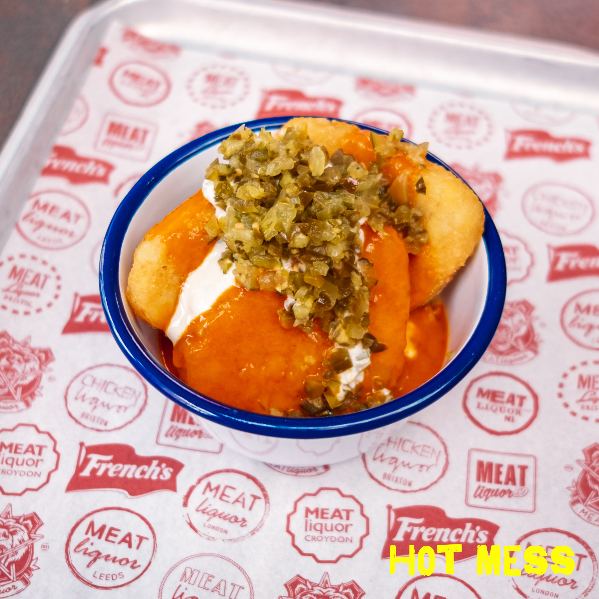 HOT MESS (V) | HASH BROWNS WITH OUR BUFFALO SAUCE, PICKLED JALAPENOS, WITH BLUE CHEESE SAUCE & DICED PICKLES Image